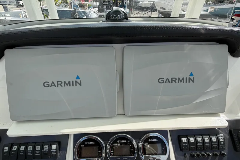 Slide: The Image of Dual Garmin displays on 2017 Robalo R242 Center Console boat dashboard. - 57