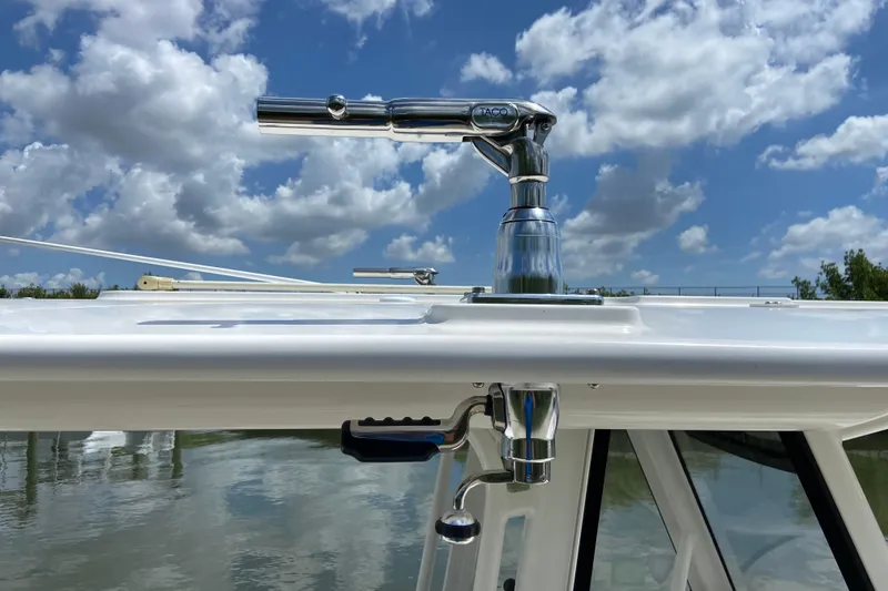 Slide: The Image of 2021 Regulator 28 boat with polished metal fittings against a cloudy sky backdrop. - 51