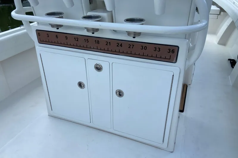 Slide: The Image of 2021 Regulator 28 boat console with built-in measuring ruler and storage compartments. - 21
