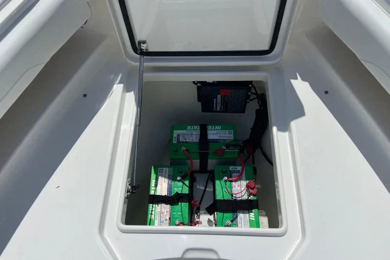 Slide: The Image of Battery compartment of a 2021 Regulator 28 boat, featuring green marine batteries. - 41