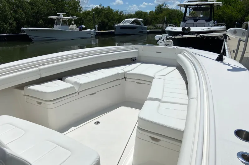 Slide: The Image of 2021 Regulator 28 boat with spacious white seating in a marina setting. - 44