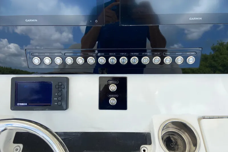 Slide: The Image of Control panel of a 2021 Regulator 28 boat with Garmin and Yamaha displays. - 30