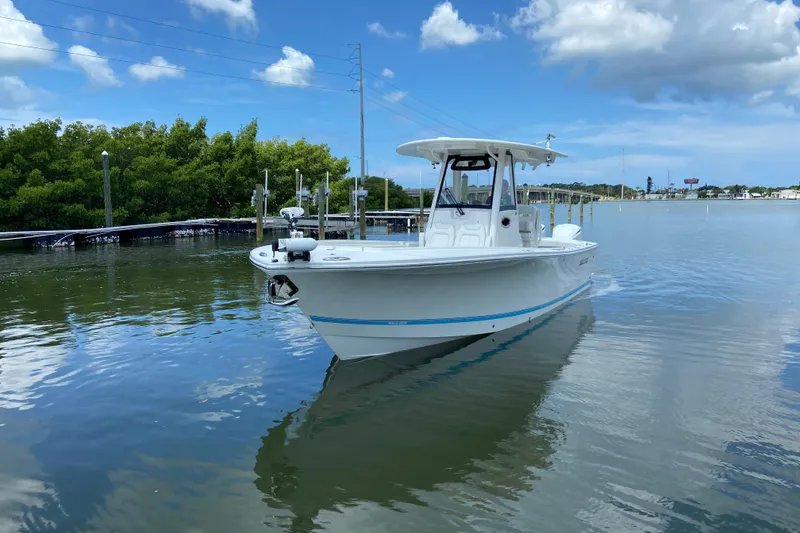 Slide: The Image of 2021 Regulator 28 boat on calm water under a partly cloudy sky. - 3