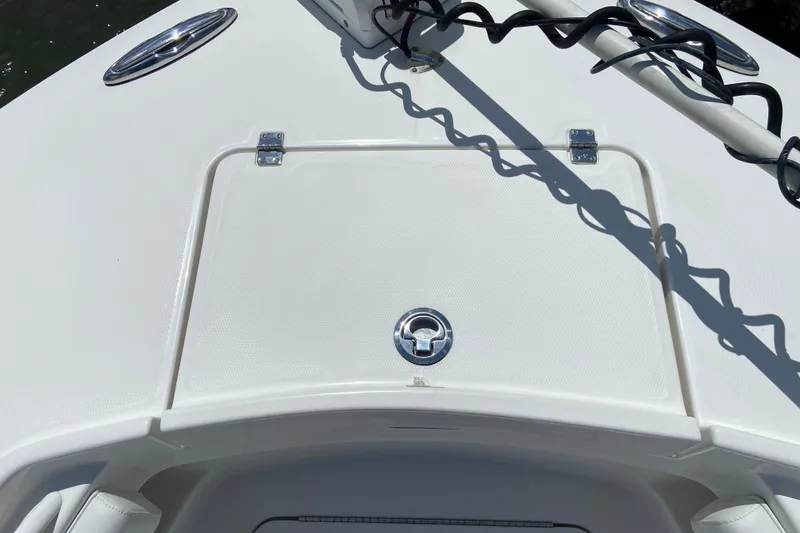 Slide: The Image of 2021 Regulator 28 boat deck with storage hatch and coiled cable. - 42
