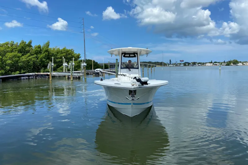 Slide: The Image of 2021 Regulator 28 boat on calm water under a partly cloudy sky. - 4
