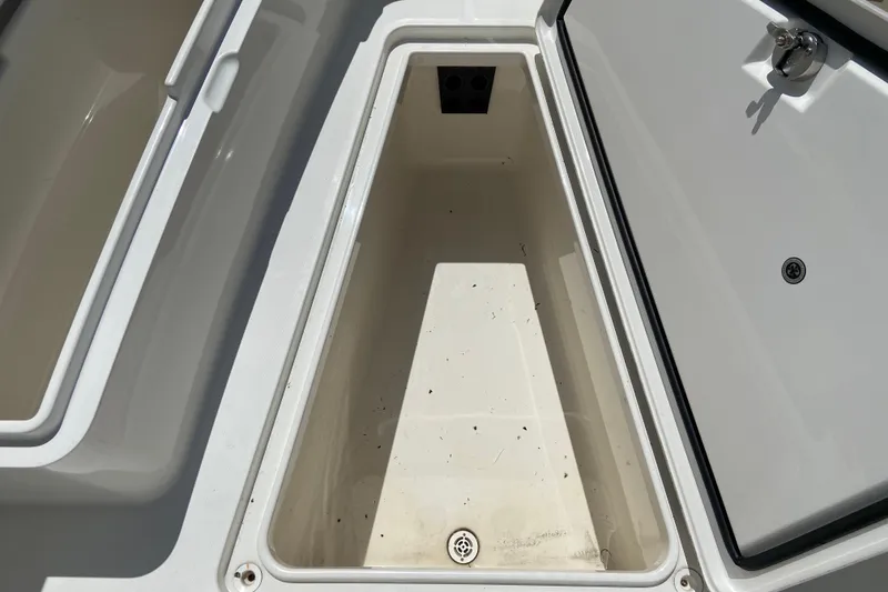 Slide: The Image of Open storage compartment on a 2021 Regulator 28 boat, showcasing interior space. - 38
