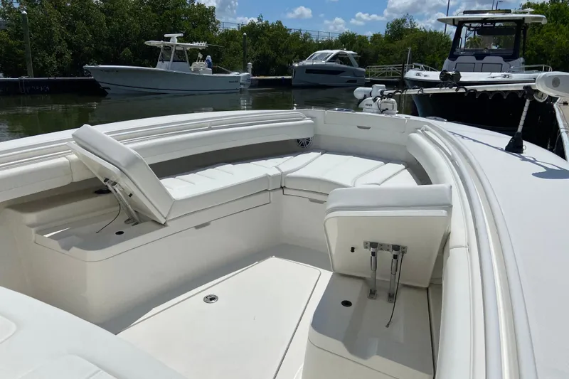 Slide: The Image of 2021 Regulator 28 boat with spacious seating, docked near other boats. - 45