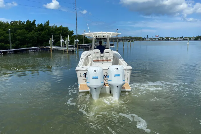 Slide: The Image of 2021 Regulator 28 boat with dual 300 horsepower engines on calm water. - 12