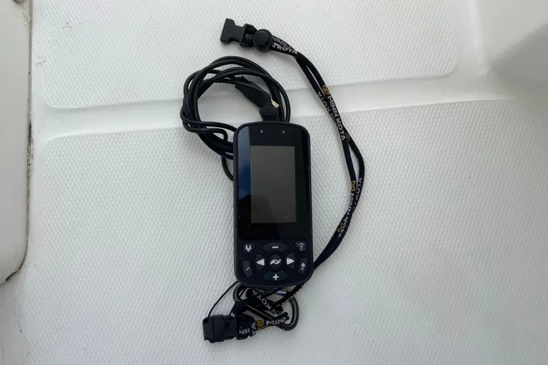 Slide: The Image of Handheld device with buttons and lanyard on Regulator 28 boat, 2021 model. - 36
