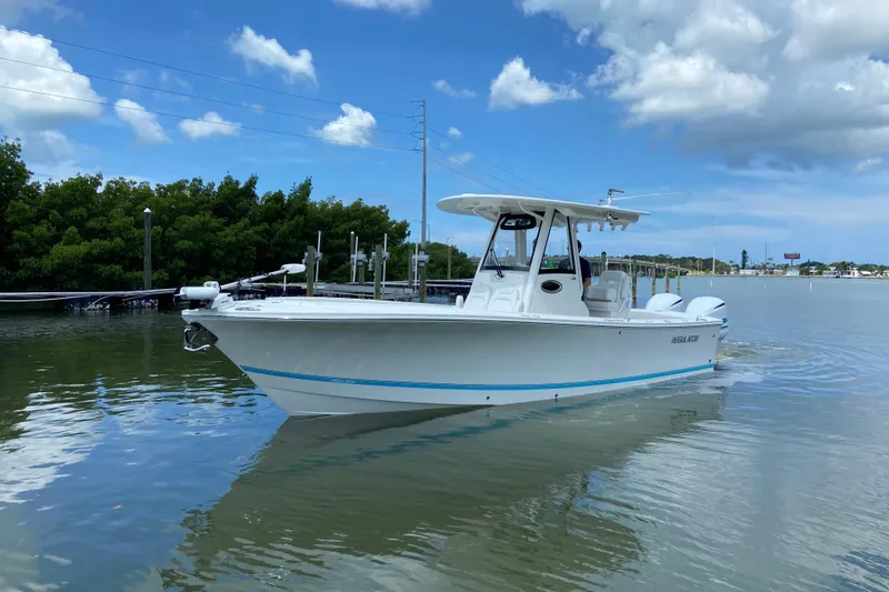 The Image of 2021 Regulator 28 boat on calm water under a blue sky. - 0