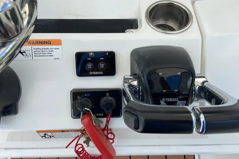 Slide: The Image of Control panel of a 2021 Regulator 28 boat featuring Yamaha throttle and warning label. - 31