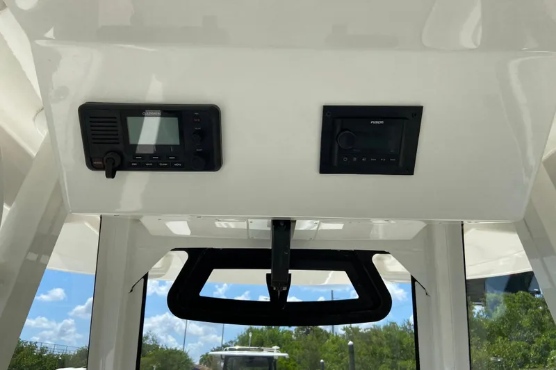 Slide: The Image of Interior view of a 2021 Regulator 28 boat featuring Garmin and Fusion electronics. - 28