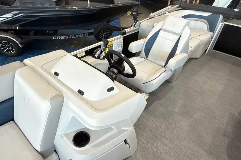 Slide: The Image of 2026 Godfrey Sweetwater 2286 SB boat interior with modern seating and steering console. - 12