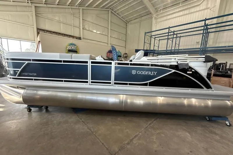 Slide: The Image of 2026 Godfrey Sweetwater 2286 SB pontoon boat in a showroom setting. - 4