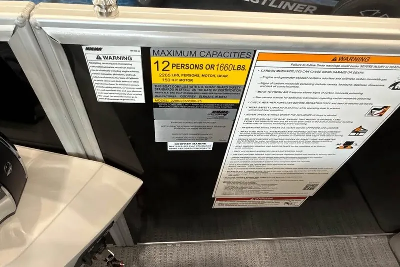 Slide: The Image of Warning labels on a 2026 Godfrey Sweetwater 2286 SB boat, showing capacity and safety information. - 16