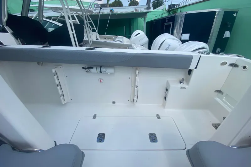 Slide: The Image of 2019 Pursuit S 328 Sport boat interior with seating and storage compartments. - 16