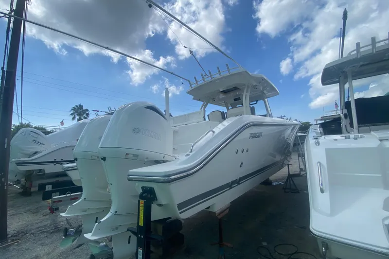 Slide: The Image of 2019 Pursuit S 328 Sport boat with Yamaha engines under a partly cloudy sky. - 4
