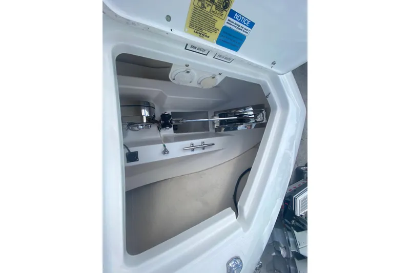 Slide: The Image of 2019 Pursuit S 328 Sport anchor compartment with winch and storage space. - 31
