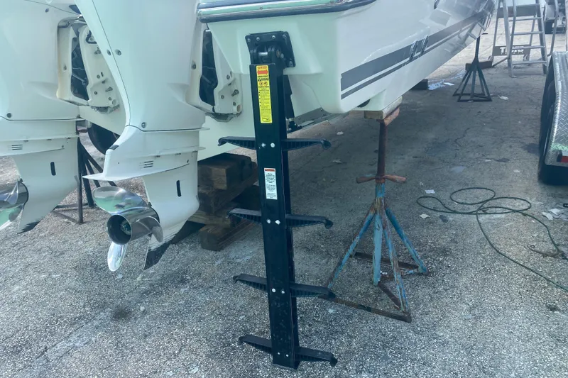 Slide: The Image of 2019 Pursuit S 328 Sport boat with dual outboard motors on stands. - 5