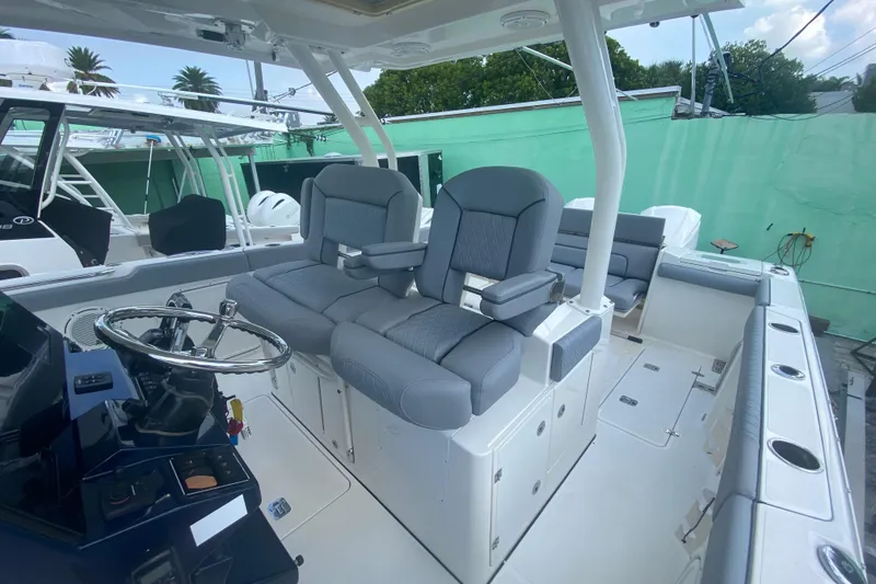 Slide: The Image of 2019 Pursuit S 328 Sport boat interior with dual helm seats and steering wheel. - 21