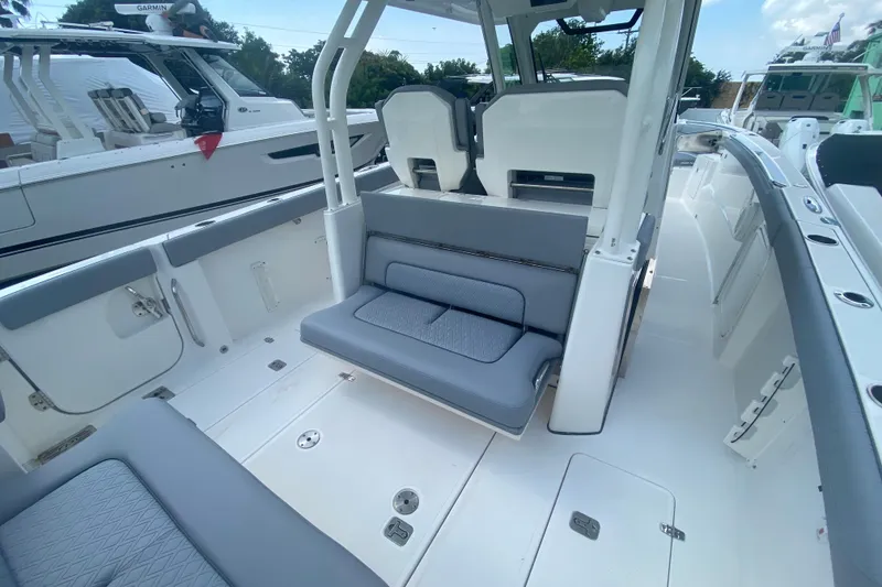 Slide: The Image of 2019 Pursuit S 328 Sport boat interior with gray seating and modern design. - 14