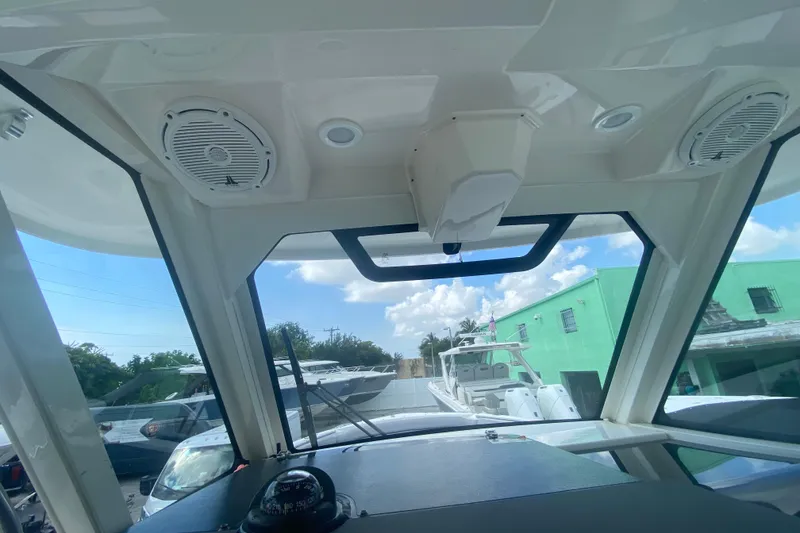Slide: The Image of Interior view of 2019 Pursuit S 328 Sport boat with speakers and windshield. - 26