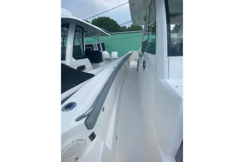 Slide: The Image of 2019 Pursuit S 328 Sport boat, sleek white exterior, side view with modern design. - 32
