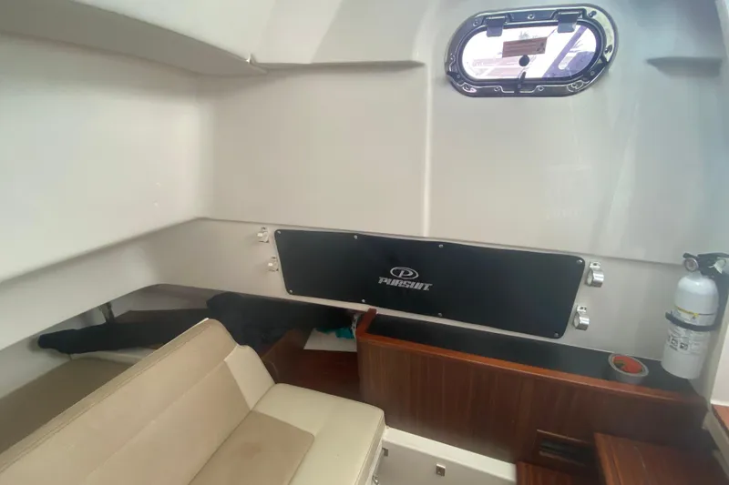 Slide: The Image of Interior of 2019 Pursuit S 328 Sport boat with seating and window. - 37