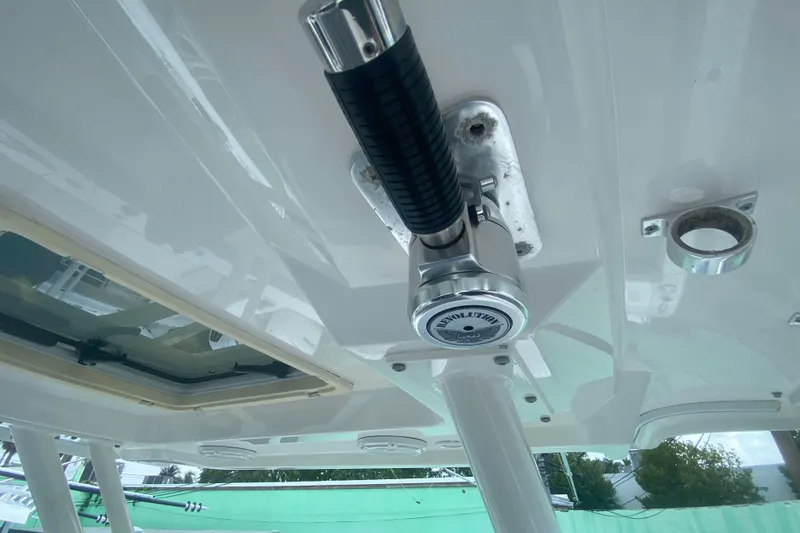 Slide: The Image of Close-up of 2019 Pursuit S 328 Sport boat's Revolution rod holder and roof details. - 25