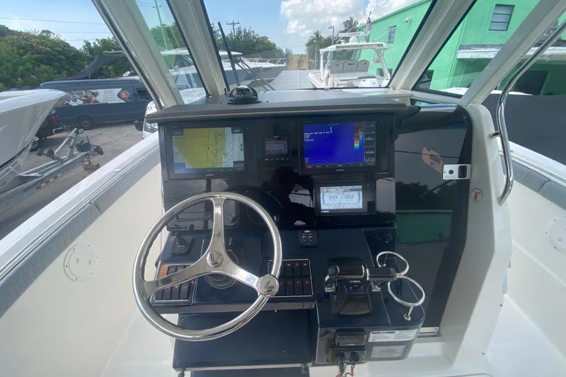 Slide: The Image of 2019 Pursuit S 328 Sport boat helm with advanced navigation displays and controls. - 23