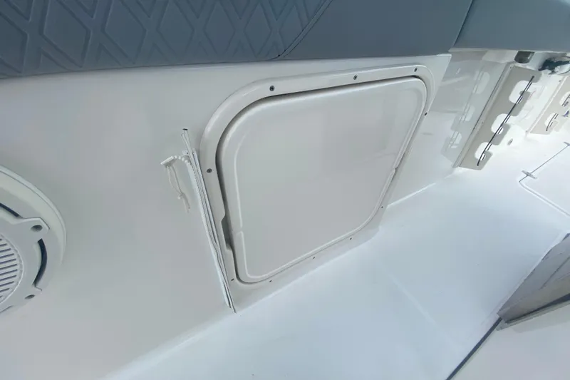 Slide: The Image of 2019 Pursuit S 328 Sport boat interior with storage compartment and speaker. - 41