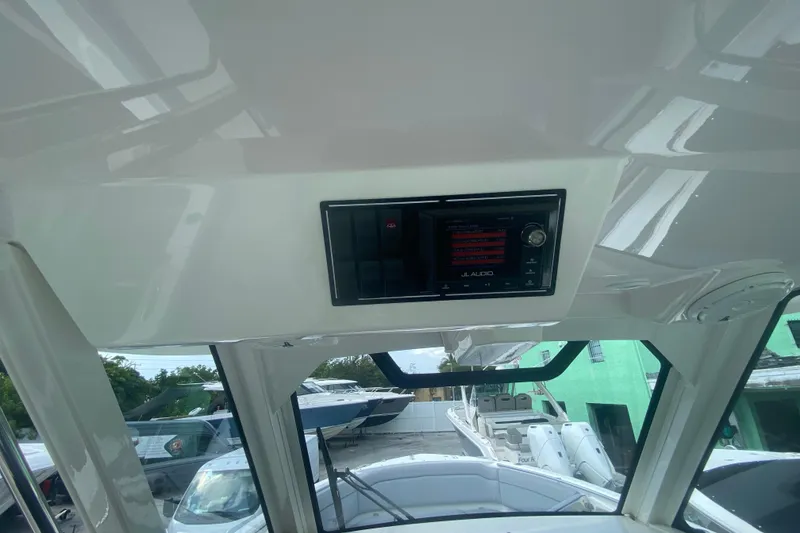 Slide: The Image of 2019 Pursuit S 328 Sport boat interior with JL Audio system, showcasing sleek design. - 22