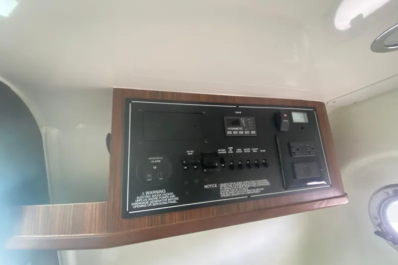Slide: The Image of Control panel of a 2019 Pursuit S 328 Sport boat, featuring various switches and outlets. - 36