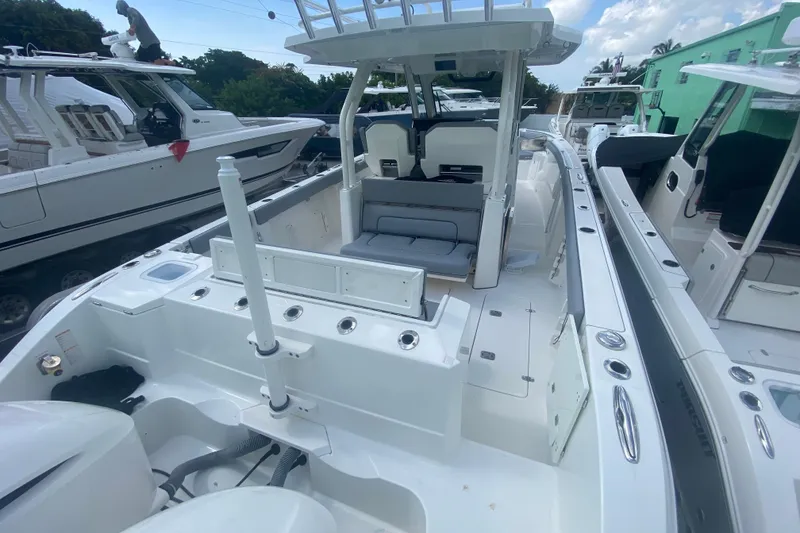 Slide: The Image of 2019 Pursuit S 328 Sport boat interior with seating and fishing rod holders. - 8