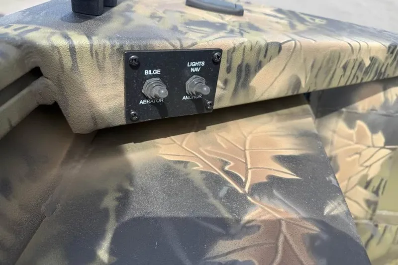 Slide: The Image of Control panel on 2027 Crestliner 1760 Retriever Jon boat with camouflage design. - 10