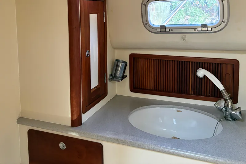 Slide: The Image of Little Harbor WhisperJet 40 (2000) yacht bathroom with sink and wooden cabinetry. - 44