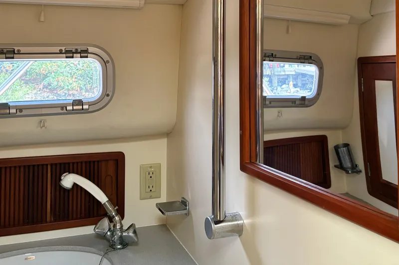 Slide: The Image of Interior of 2000 Little Harbor WhisperJet 40 yacht bathroom with sink, mirror, and porthole. - 48