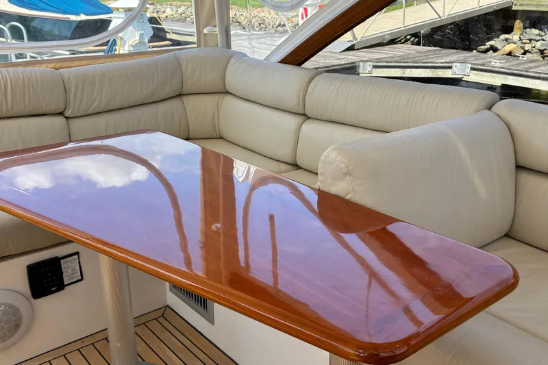 Slide: The Image of Luxurious interior of 2000 Little Harbor WhisperJet 40 with polished wood table and beige seating. - 10