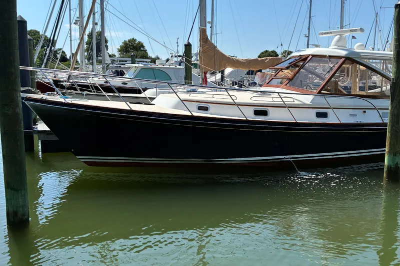 Slide: The Image of Little Harbor WhisperJet 40, 2000 model, docked in a marina with surrounding boats. - 59