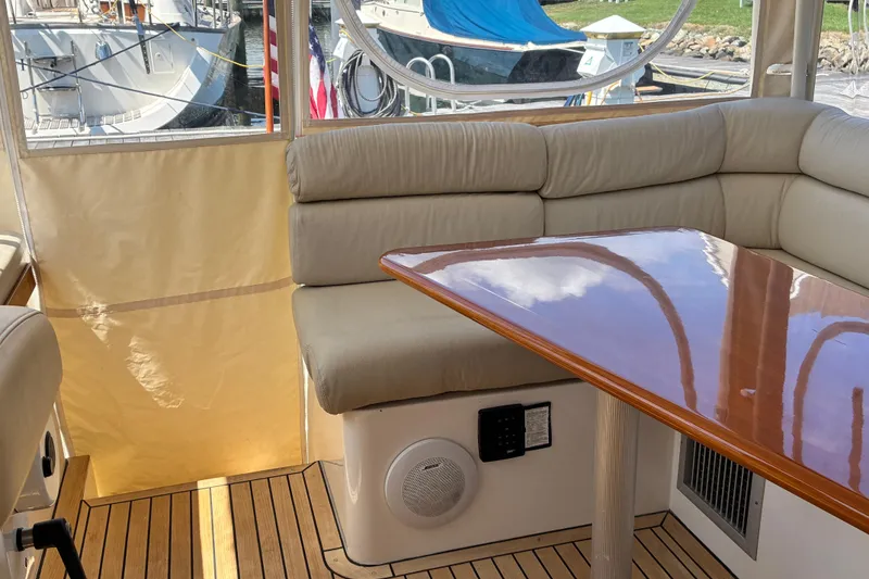 Slide: The Image of Interior of 2000 Little Harbor WhisperJet 40 with beige seating and wooden table. - 12