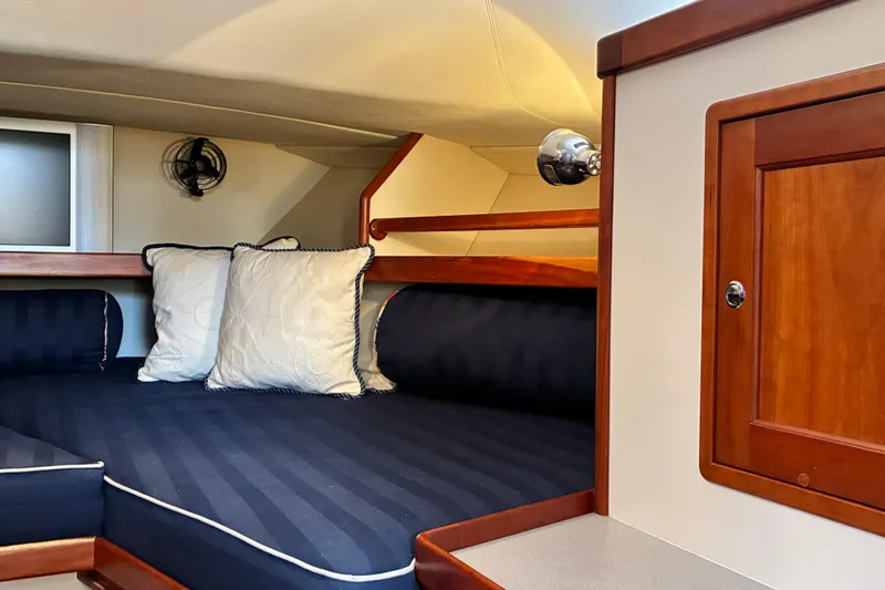 Slide: The Image of Cozy cabin interior of 2000 Little Harbor WhisperJet 40 with striped bedding and wooden accents. - 42
