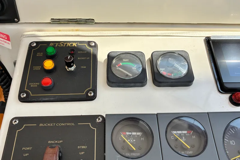 Slide: The Image of Control panel of a 2000 Little Harbor WhisperJet 40 boat with gauges and buttons. - 15