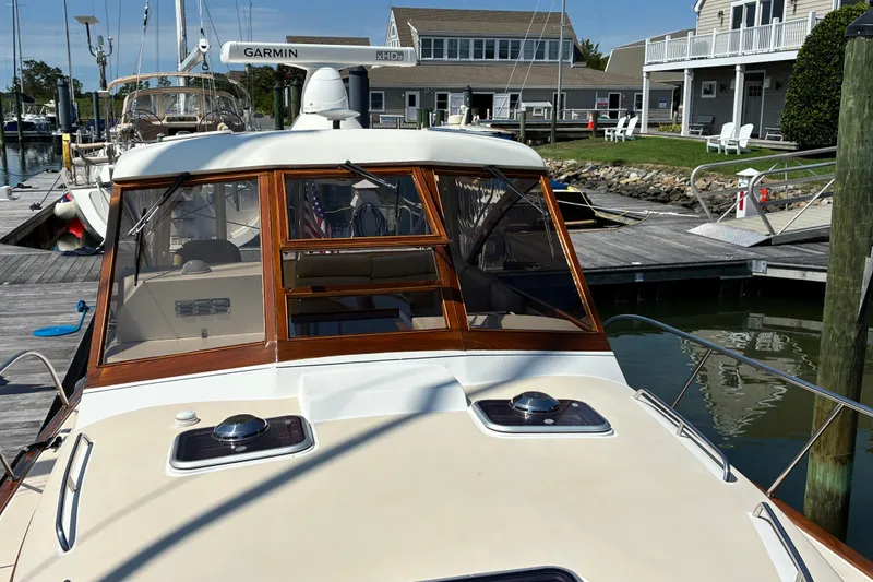 Slide: The Image of Little Harbor WhisperJet 40, 2000 model, docked at a marina with wooden accents. - 7