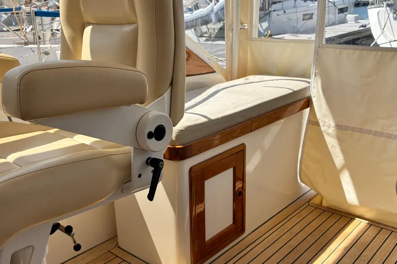Slide: The Image of Interior of 2000 Little Harbor WhisperJet 40, featuring beige seating and wooden accents. - 11