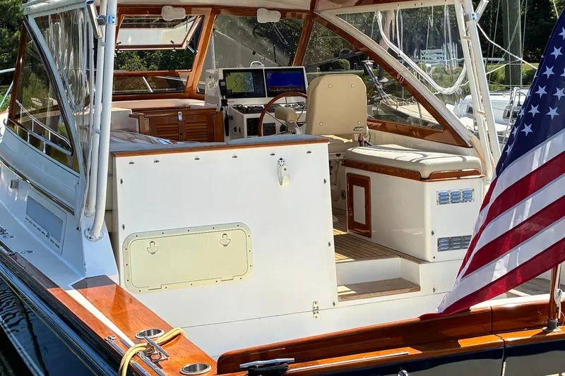 Slide: The Image of 2000 Little Harbor WhisperJet 40 yacht interior with American flag, showcasing helm and seating area. - 4