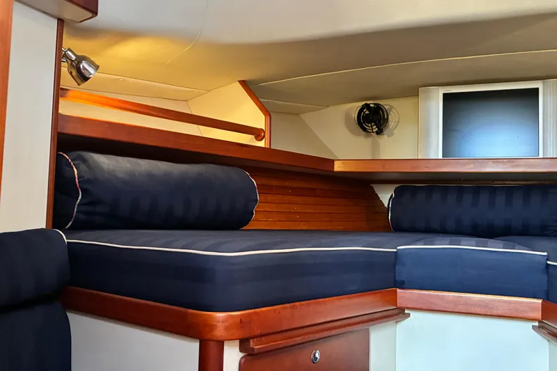 Slide: The Image of Interior cabin of 2000 Little Harbor WhisperJet 40 with blue cushions and wooden accents. - 41