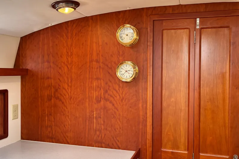 Slide: The Image of Interior of 2000 Little Harbor WhisperJet 40 with wooden paneling and brass instruments. - 32