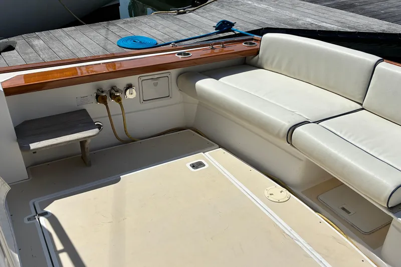 Slide: The Image of Cockpit seating area of 2000 Little Harbor WhisperJet 40 boat with wooden accents. - 5