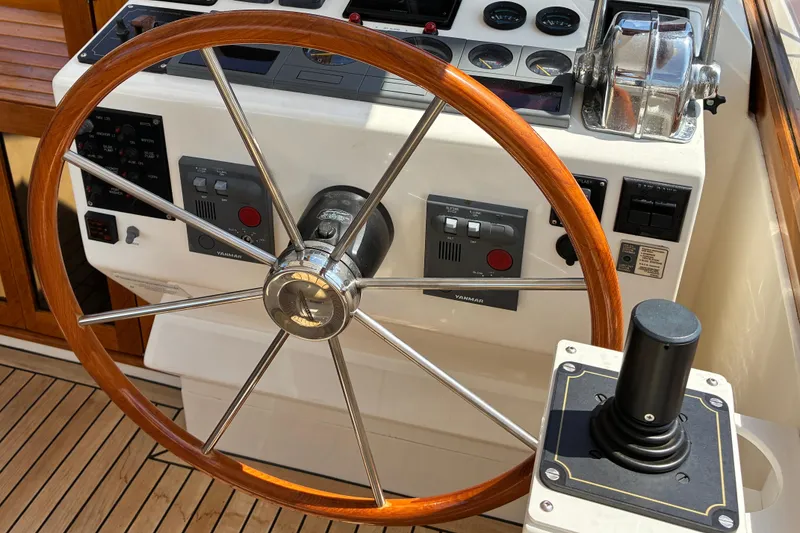 Slide: The Image of Steering wheel and controls of a 2000 Little Harbor WhisperJet 40 yacht. - 16