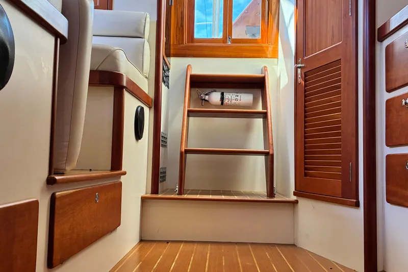 Slide: The Image of Interior of 2000 Little Harbor WhisperJet 40, featuring wooden stairs and cabinetry. - 23